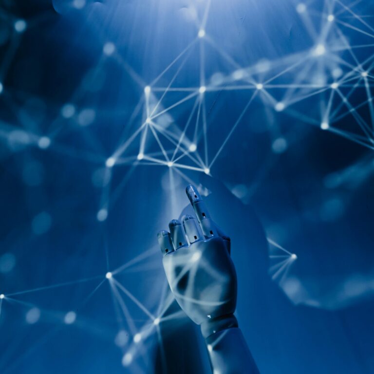 A robotic hand reaching into a digital network on a blue background, symbolizing AI technology.